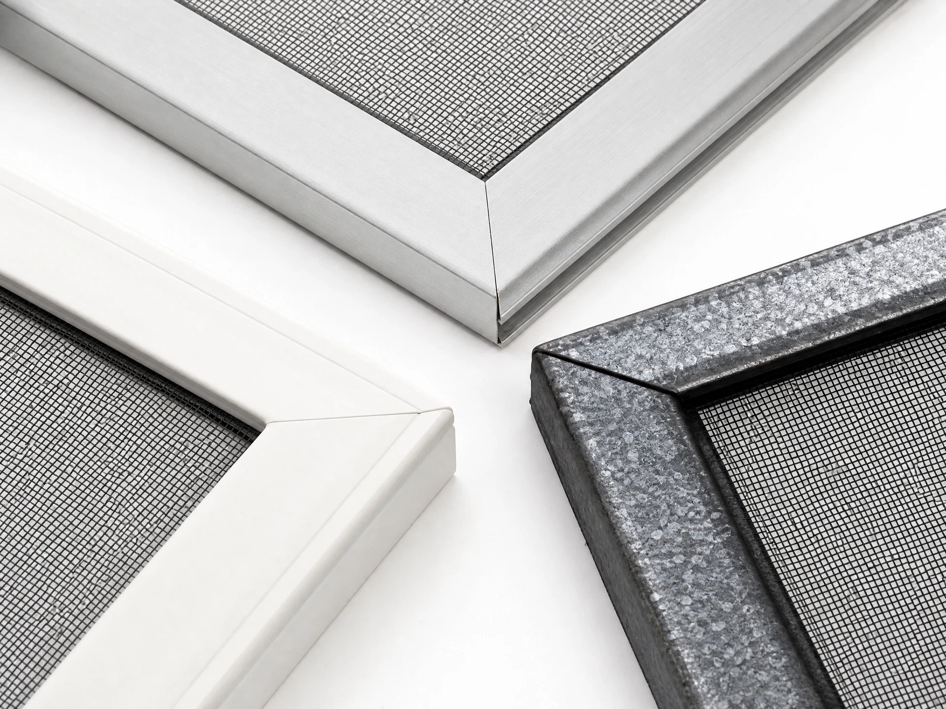 Window screen frame corner joints showing different frame materials for comparison